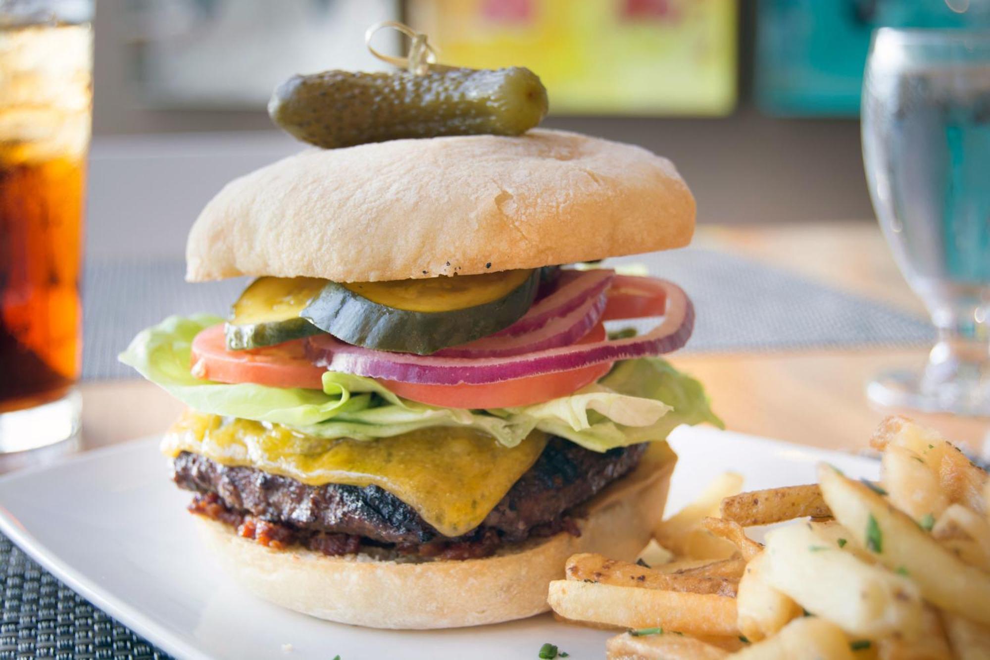 Hotel Murano Tacoma Exterior photo A cheeseburger with lettuce, tomato, onion, and pickle